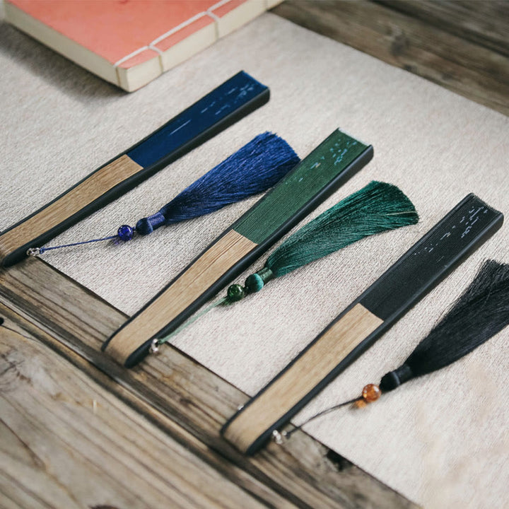 Abanico plegable de bambú con borlas y diseño de hojas de bambú y Buddha Stones