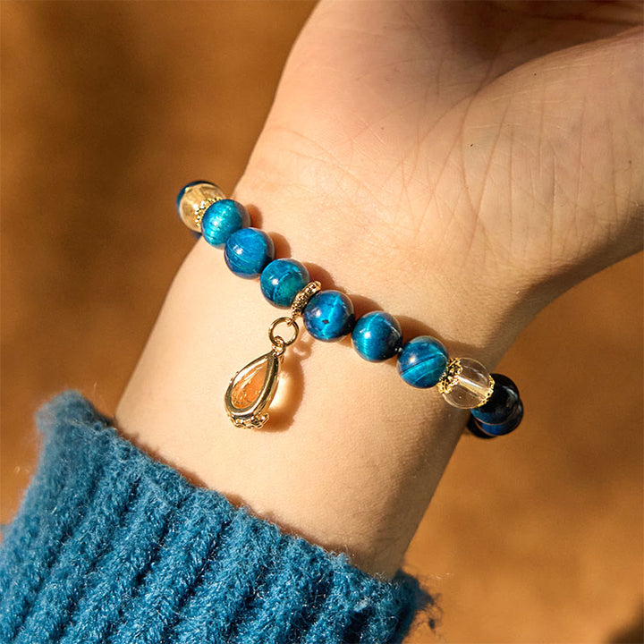 Pulsera de fuerza con gotas de agua de cristal blanco y ojo de tigre azul de Buddha Stones