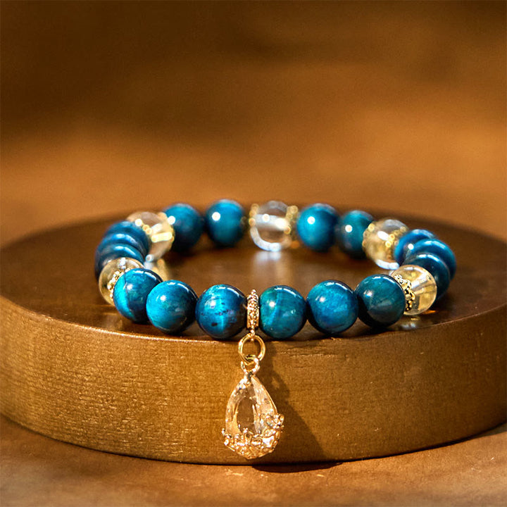 Pulsera de fuerza con gotas de agua de cristal blanco y ojo de tigre azul de Buddha Stones