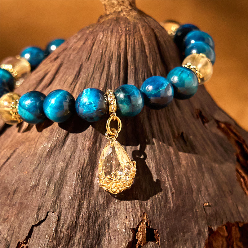 Pulsera de fuerza con gotas de agua de cristal blanco y ojo de tigre azul de Buddha Stones