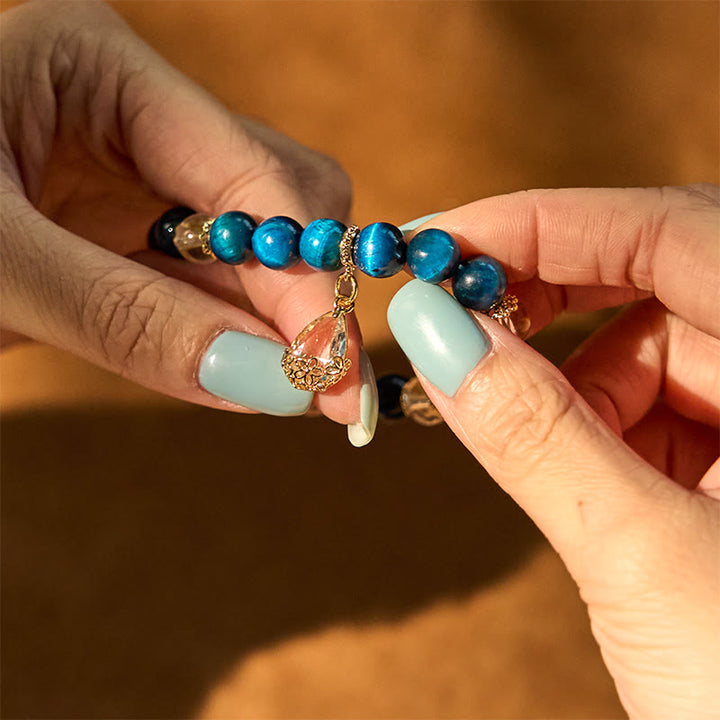 Pulsera de fuerza con gotas de agua de cristal blanco y ojo de tigre azul de Buddha Stones