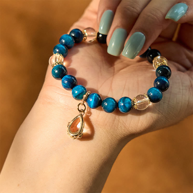 Pulsera de fuerza con gotas de agua de cristal blanco y ojo de tigre azul de Buddha Stones
