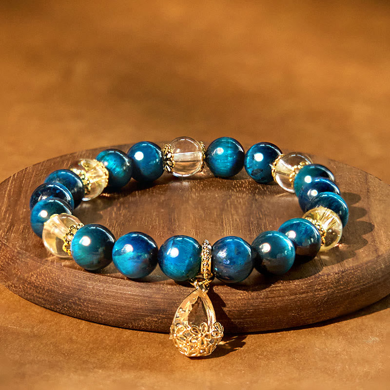 Pulsera de fuerza con gotas de agua de cristal blanco y ojo de tigre azul de Buddha Stones