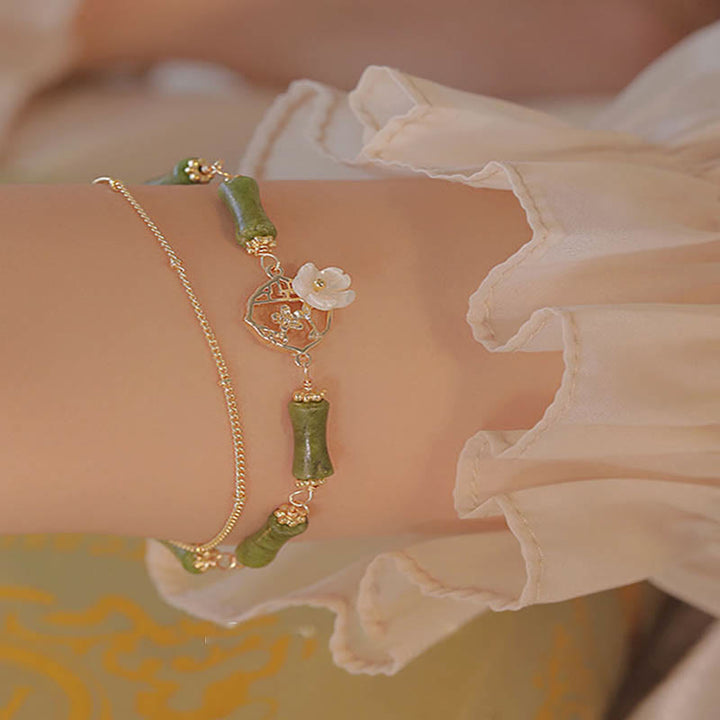 Pulsera de doble capa de cobre chapado en oro de 14 quilates con Buddha Stones , peridoto, flor de bambú y riqueza