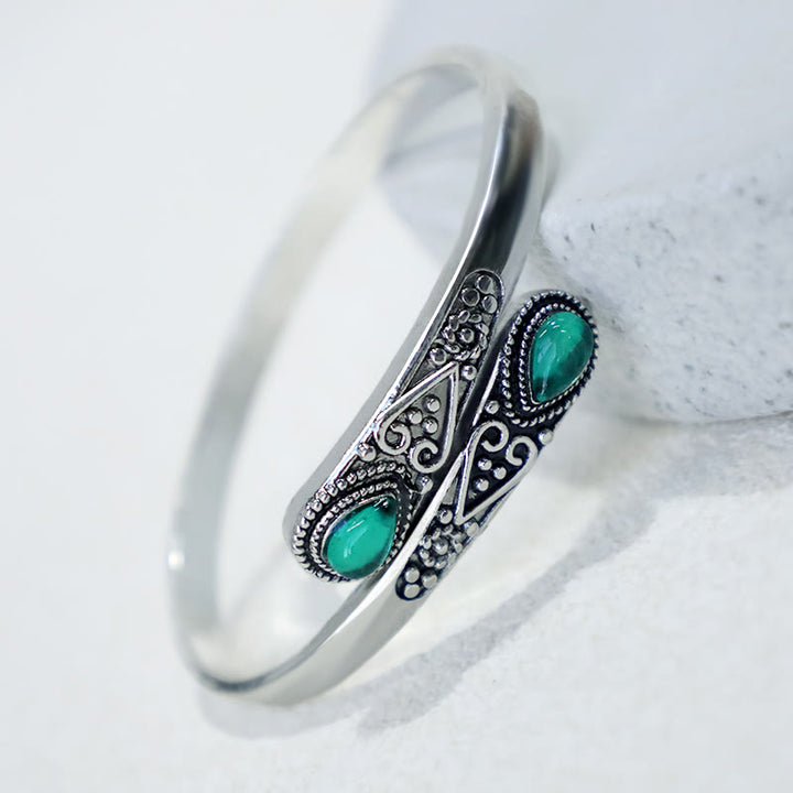 Brazalete de pulsera curativo con patrón de gota de agua de circonita con Buddha Stones