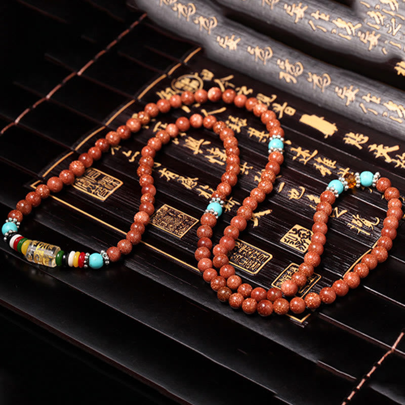Buddha Stones 108 cuentas Mala Goldstone Om Mani Padme Hum esvástica pulsera de confianza