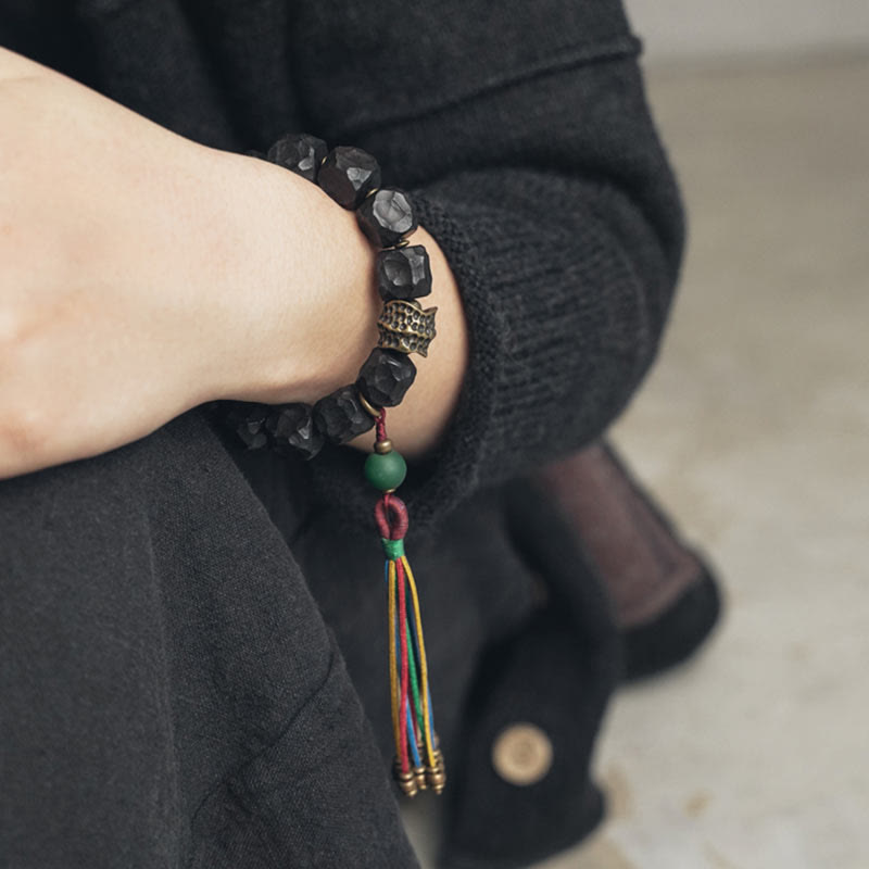 Pulsera Mala de muñeca con borla de paz de cobre y madera de ébano del Tíbet