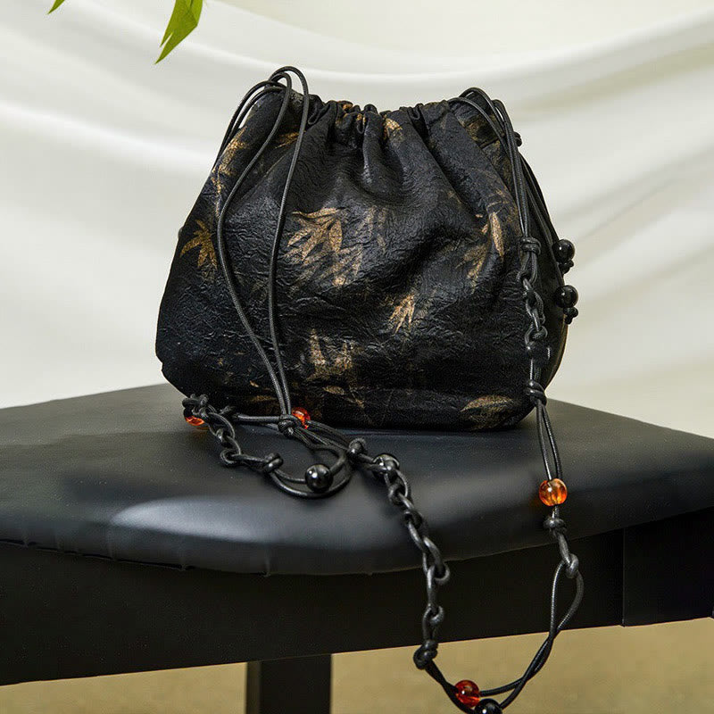 Buddha Stones Bolso bandolera de acetato con estampado de hojas de bambú amarillas - image 1