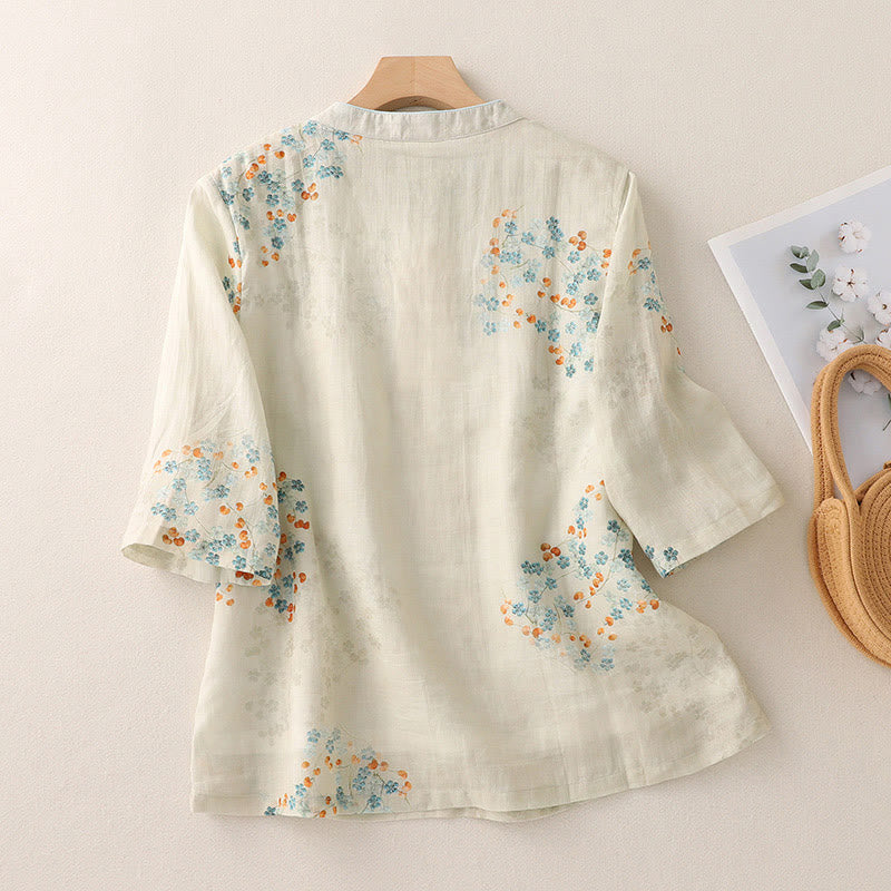 Camisa de manga tres cuartos con botones de rana, flores azules y Buddha Stones, con estampado de hojas naranjas y diseño de piedras de Buda. - image 1