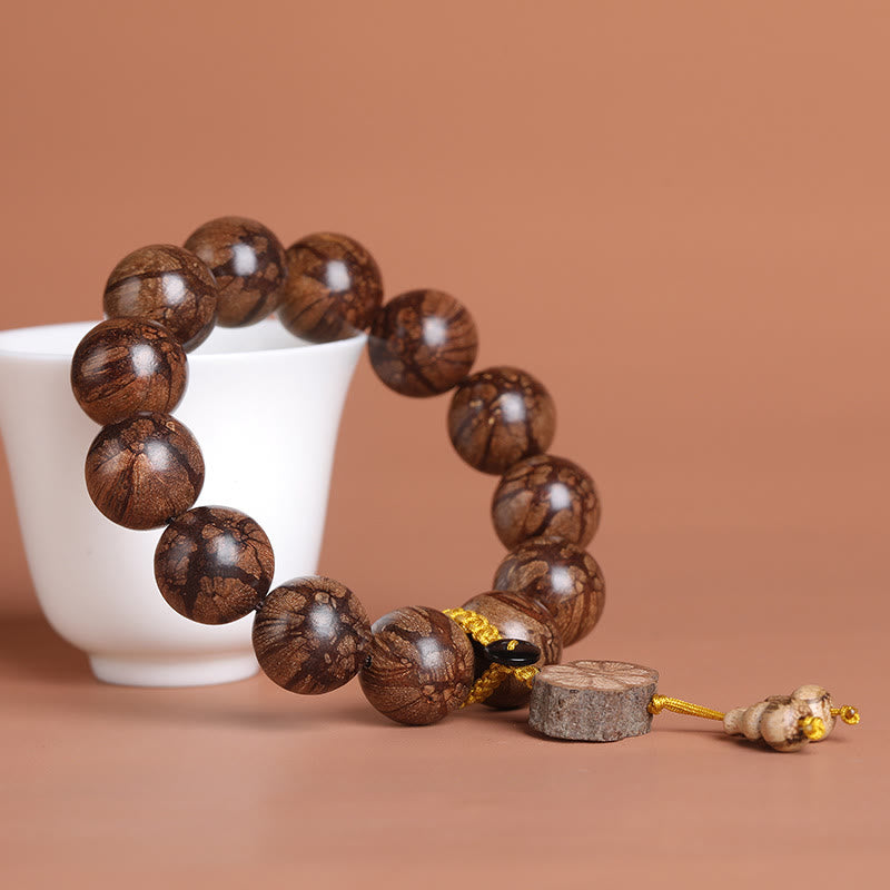 Pulsera de paz interior de madera de ciruelo con piedras de Buda