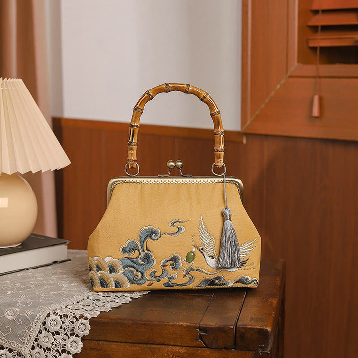 Bolso de asa de bambú con bordado de grullas nubes auspiciosas de piedras de Buda