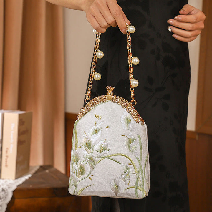 Bolso de mano con asa de metal bordado de calas y piedras de Buda, bolso bandolera