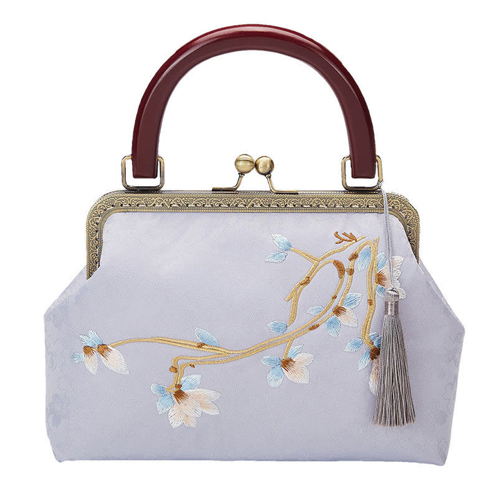 Bolso cruzado con bordado de flores y piedras de Buda