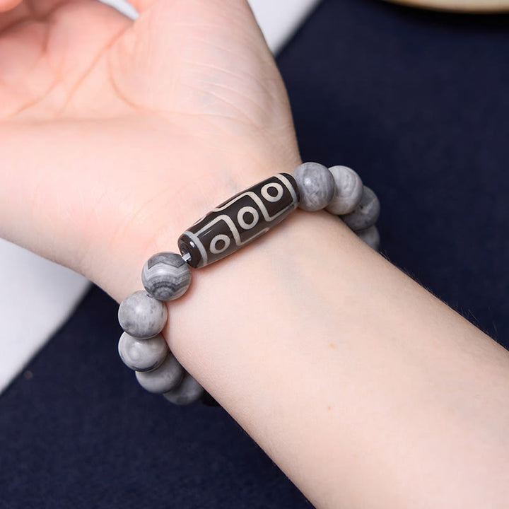 Pulsera positiva de jaspe Picasso con cuentas Dzi tibetanas de nueve ojos con Buddha Stones