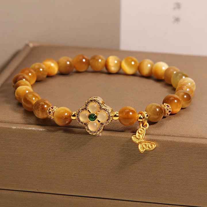 Pulsera de protección con ojo de tigre, trébol de cuatro hojas y mariposa de Buddha Stones