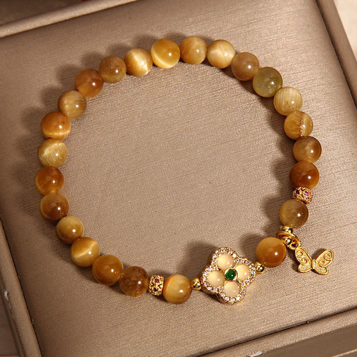 Pulsera de protección con ojo de tigre, trébol de cuatro hojas y mariposa de Buddha Stones
