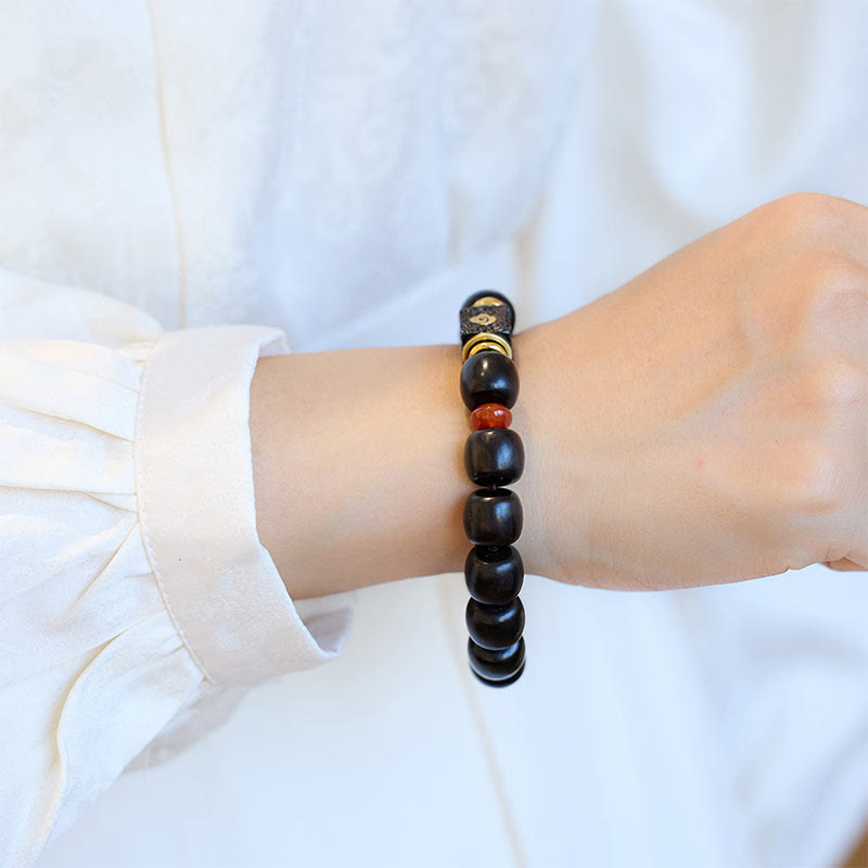 Buddha Stones Pulsera de Madera de Ébano con Nubes Auspiciosas Grabadas para la Calma