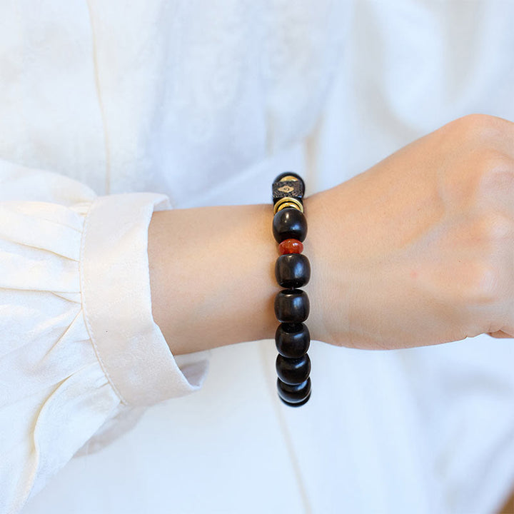Buddha Stones Pulsera de Madera de Ébano con Nubes Auspiciosas Grabadas para la Calma