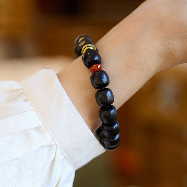 Buddha Stones Pulsera de Madera de Ébano con Nubes Auspiciosas Grabadas para la Calma