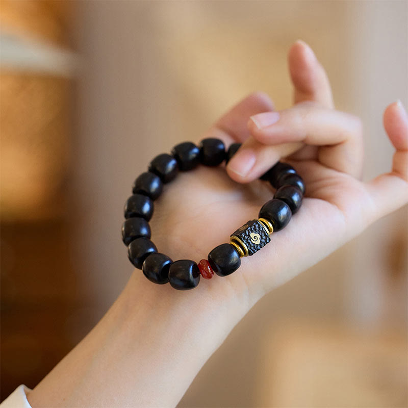 Buddha Stones Pulsera de Madera de Ébano con Nubes Auspiciosas Grabadas para la Calma