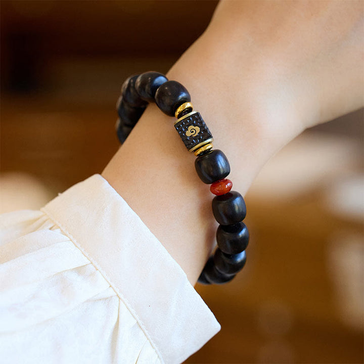 Buddha Stones Pulsera de Madera de Ébano con Nubes Auspiciosas Grabadas para la Calma