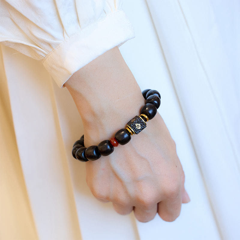 Buddha Stones Pulsera de Madera de Ébano con Nubes Auspiciosas Grabadas para la Calma