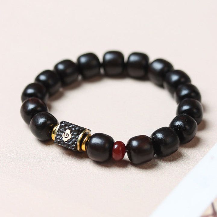 Buddha Stones Pulsera de Madera de Ébano con Nubes Auspiciosas Grabadas para la Calma