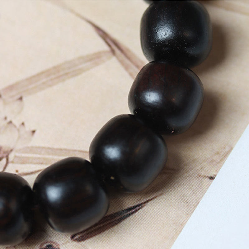 Buddha Stones Pulsera de Madera de Ébano con Nubes Auspiciosas Grabadas para la Calma