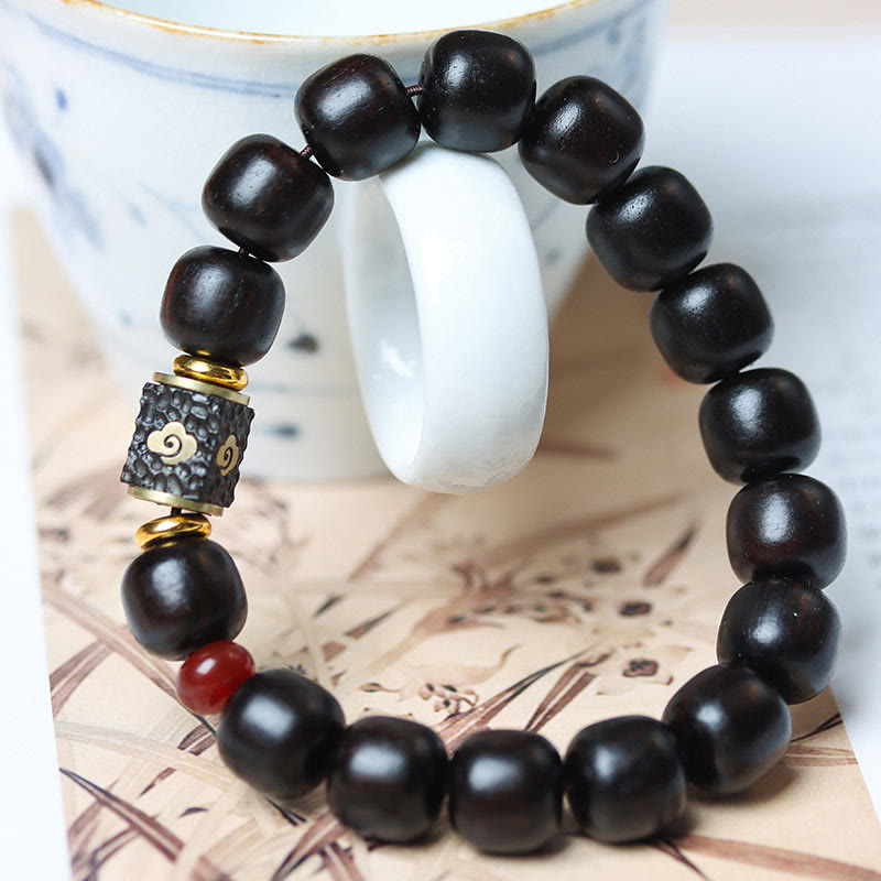 Buddha Stones Pulsera de Madera de Ébano con Nubes Auspiciosas Grabadas para la Calma