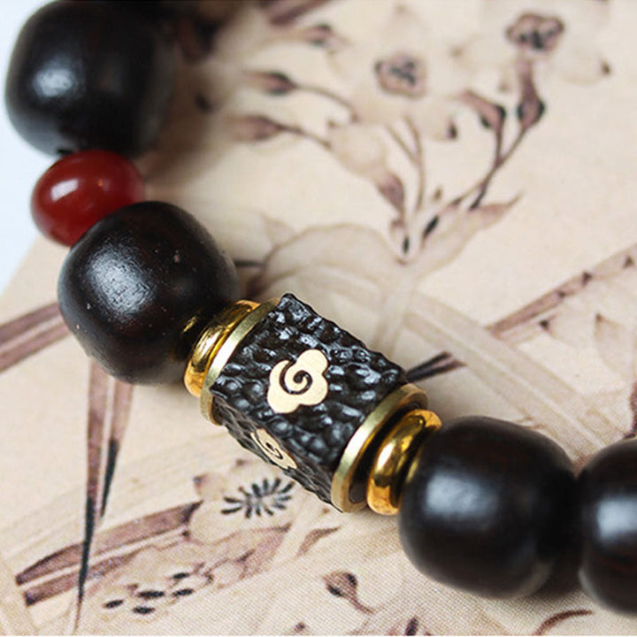 Buddha Stones Pulsera de Madera de Ébano con Nubes Auspiciosas Grabadas para la Calma