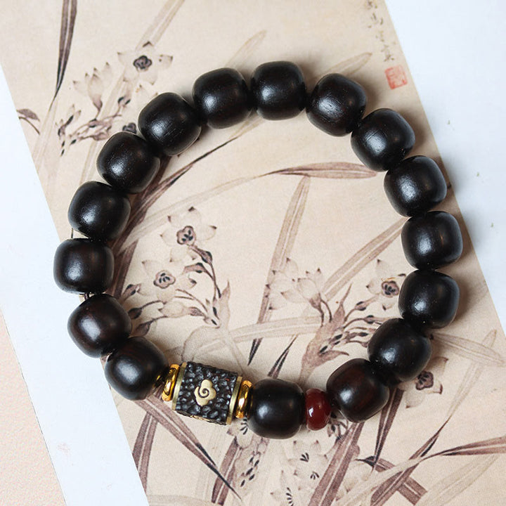Buddha Stones Pulsera de Madera de Ébano con Nubes Auspiciosas Grabadas para la Calma