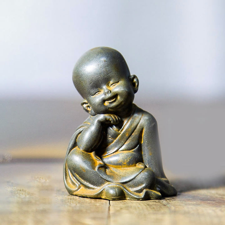 Estatua de resina fundida oxidada con polvo de hierro de un pequeño monje meditando Buddha Stones para decoración de escritorio