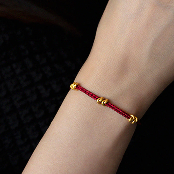 Pulsera trenzada de cuerda con diseño de nudo de los deseos hecha a mano con Buddha Stones en oro 999