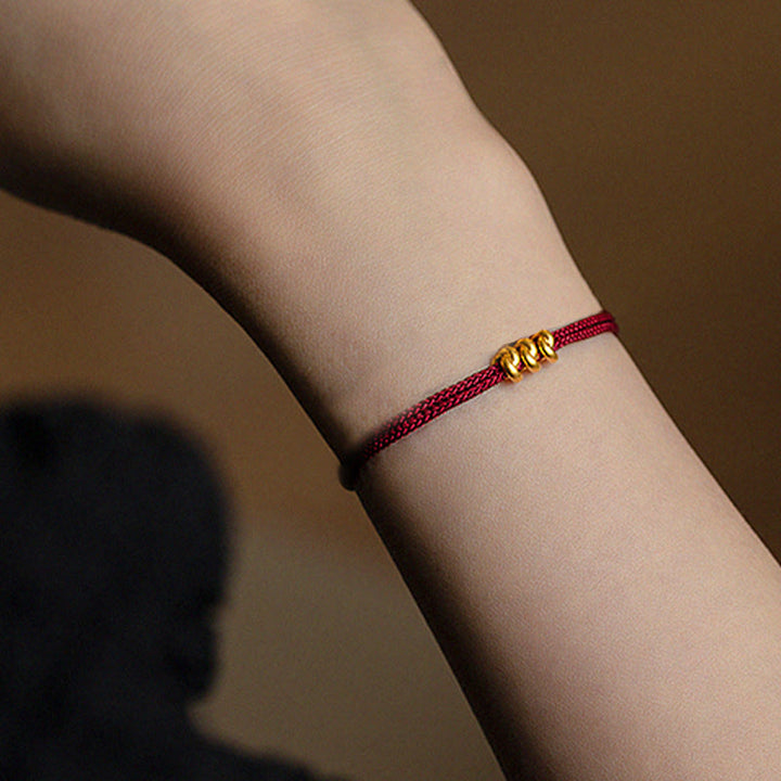 Pulsera trenzada de cuerda con diseño de nudo de los deseos hecha a mano con Buddha Stones en oro 999