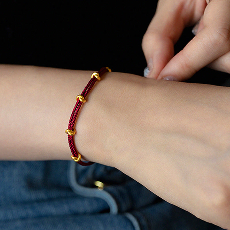 Pulsera trenzada de cuerda con diseño de nudo de los deseos hecha a mano con Buddha Stones en oro 999