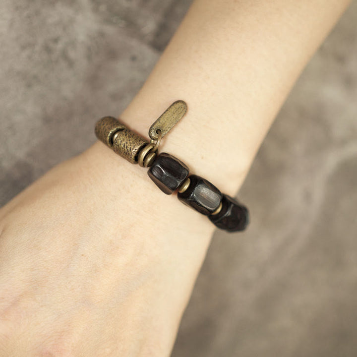 Pulsera de cuentas de cobre y madera de ébano con Buddha Stones y diseño vintage de la paz