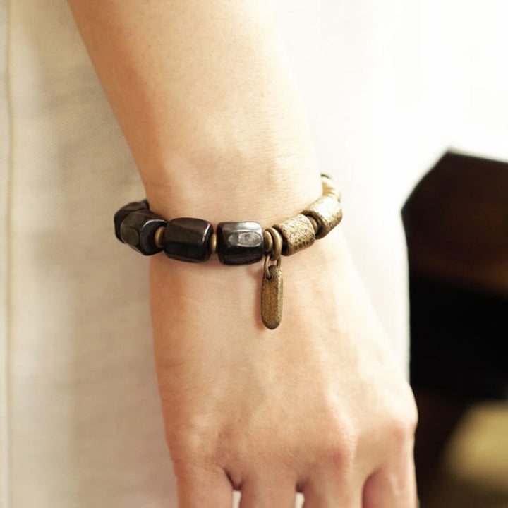 Pulsera de cuentas de cobre y madera de ébano con Buddha Stones y diseño vintage de la paz