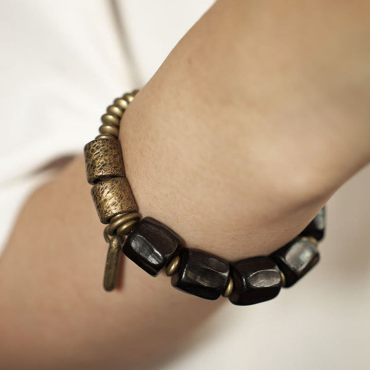 Pulsera de cuentas de cobre y madera de ébano con Buddha Stones y diseño vintage de la paz