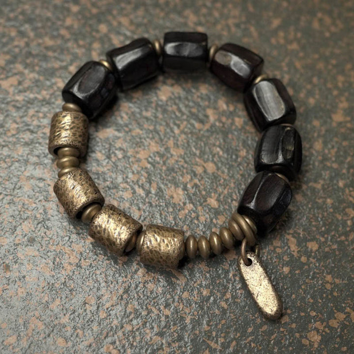 Pulsera de cuentas de cobre y madera de ébano con Buddha Stones y diseño vintage de la paz