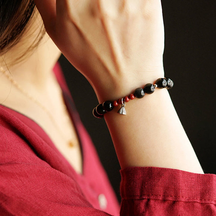Pulsera de fuerza con dije de loto y cinabrio de obsidiana negra natural de Buddha Stones