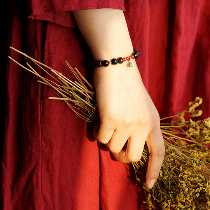Pulsera de fuerza con dije de loto y cinabrio de obsidiana negra natural de Buddha Stones