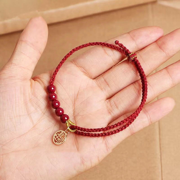 Pulsera trenzada hecha a mano con hilo rojo y bendición de cuentas de cinabrio con caracteres Fu y Buddha Stones
