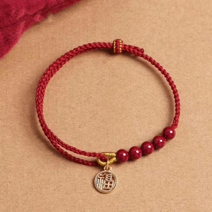 Pulsera trenzada hecha a mano con hilo rojo y bendición de cuentas de cinabrio con caracteres Fu y Buddha Stones