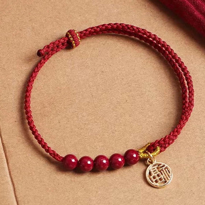 Pulsera trenzada hecha a mano con hilo rojo y bendición de cuentas de cinabrio con caracteres Fu y Buddha Stones
