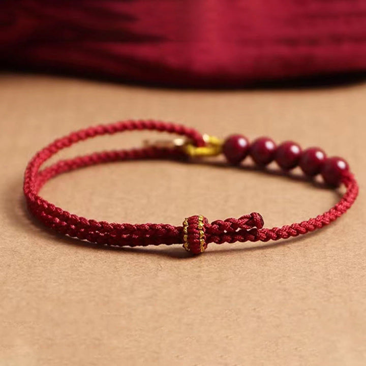 Pulsera trenzada hecha a mano con hilo rojo y bendición de cuentas de cinabrio con caracteres Fu y Buddha Stones