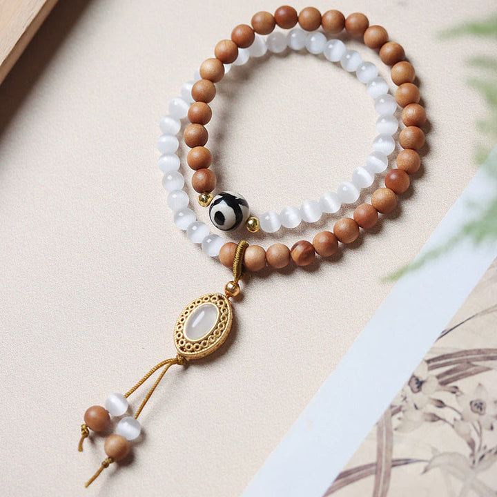 Pulsera protectora de cristal con cuentas Dzi de tres ojos y ojo de gato de sándalo y Buddha Stones