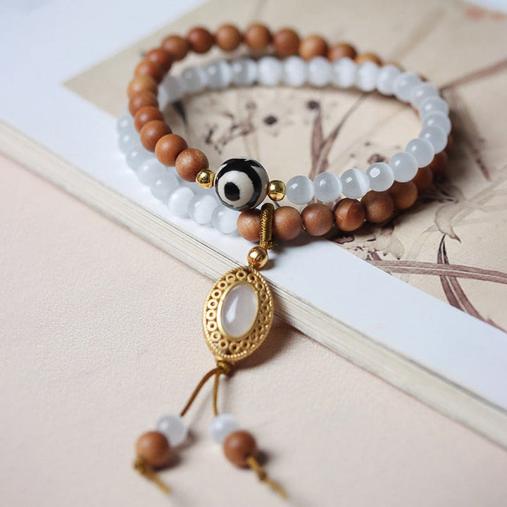 Pulsera protectora de cristal con cuentas Dzi de tres ojos y ojo de gato de sándalo y Buddha Stones