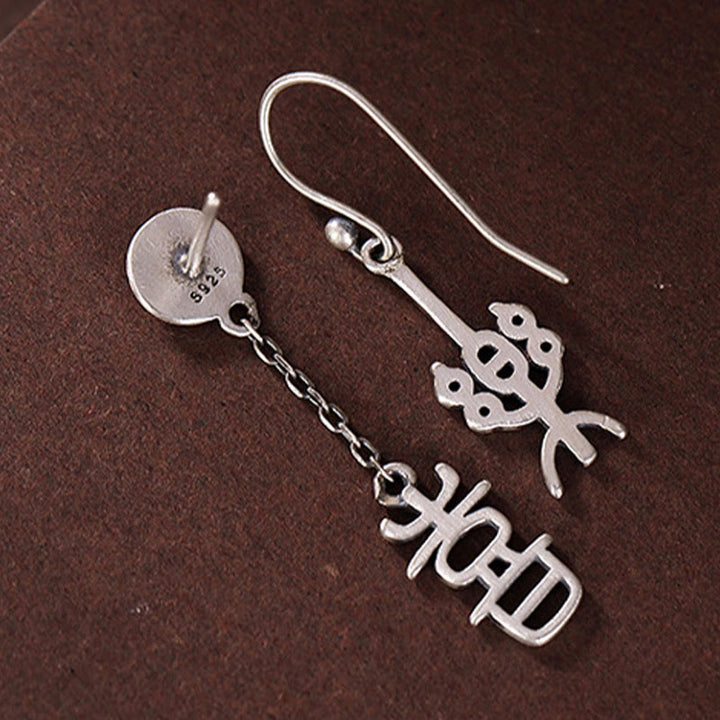 Pendientes de protección con caracteres chinos "Ping An" y "Xi Le" en plata de ley 925 con Buddha Stones