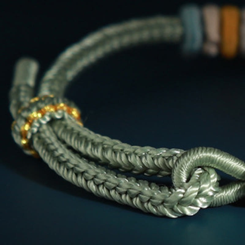 Pulsera de cuatro hilos con Buddha Stones y flor de durazno