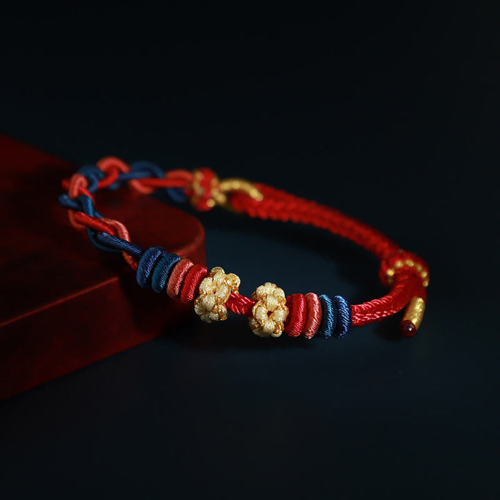 Pulsera de cuatro hilos con Buddha Stones y flor de durazno